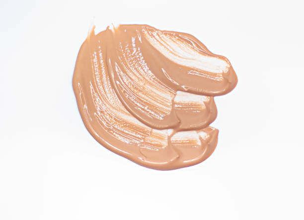 istock liquid tonal cream smear. Light brown makeup concealer stain isolated on white background. 1340592523