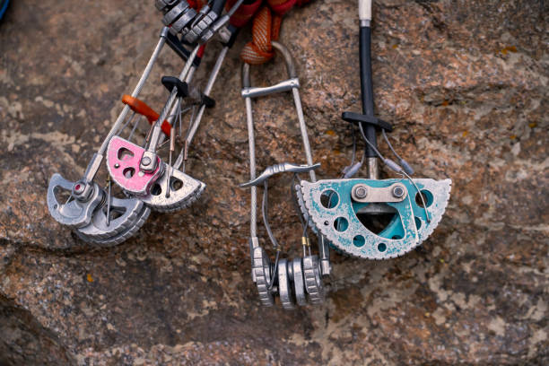 vintage rugged camalots, friends on the cliff. Climbing gear, vintage rugged camalots, friends lie on the cliff ground stopper stock pictures, royalty-free photos & images