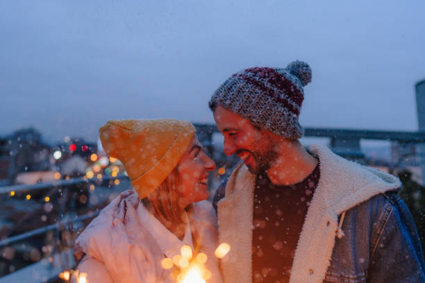 istock Romantic couple with sparklers on a rooftop terrace 1340598165