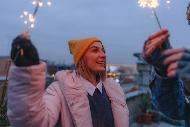 istock Romantic couple with sparklers on a rooftop terrace 1340598166