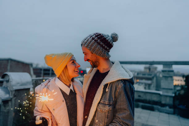 istock Romantic couple with sparklers on a rooftop terrace 1340598720