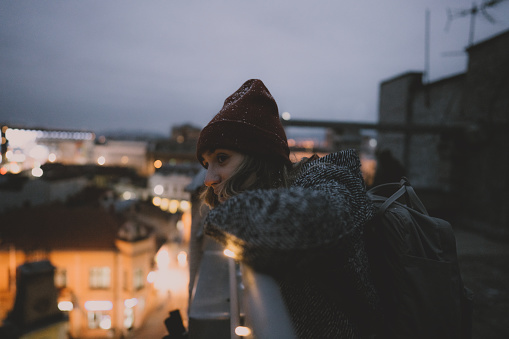 Photo of a young woman enjoying on a rooftop terrace