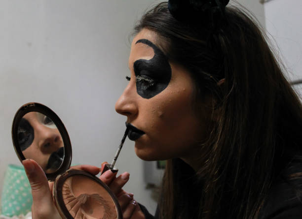 istock young woman doing a scary makeup for Halloween 1340598991