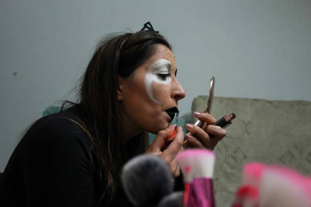 istock young girl putting on horror makeup for Halloween 1340599059