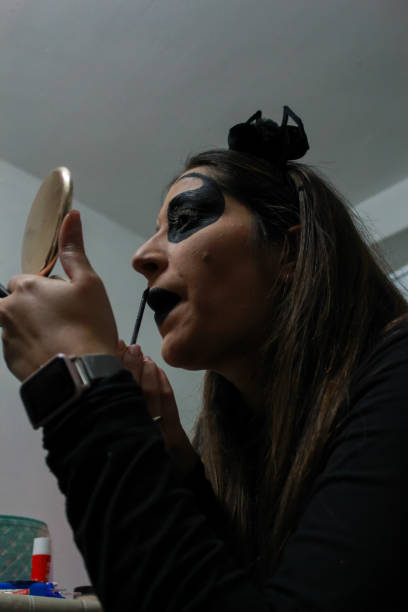istock young girl putting on horror makeup for Halloween 1340599084