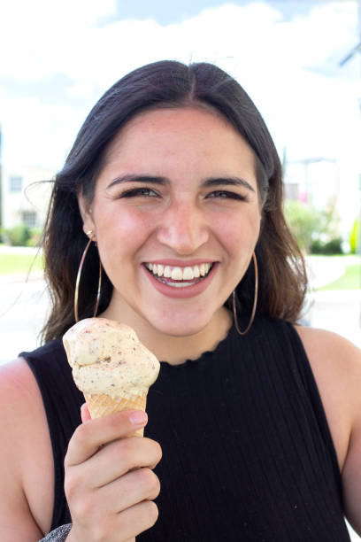 istock young woman eating ice cream 1340599939