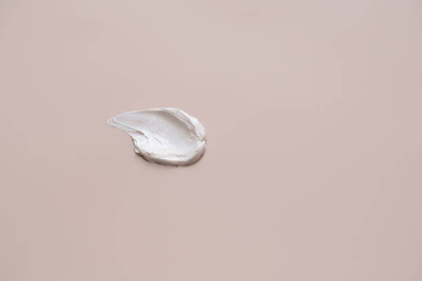 istock The texture of white delicate cream on a beige background. 1340603993