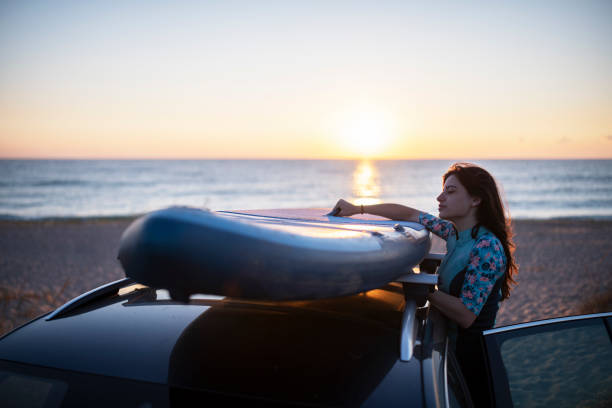 istock Female Surfer Preparing For Surfing At Sunrise. 1340604441