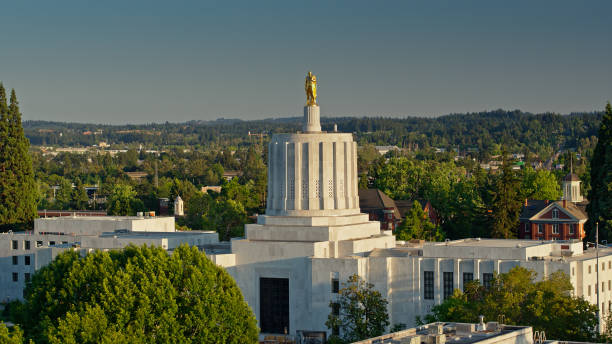 Gold Pioneer Staring out from Oregon State Capitol Building Aerial shot of the state capitol building in Salem, Oregon on a summer evening. 

Airspace authorization was obtained from the FAA for this operation. oregon us state stock pictures, royalty-free photos & images