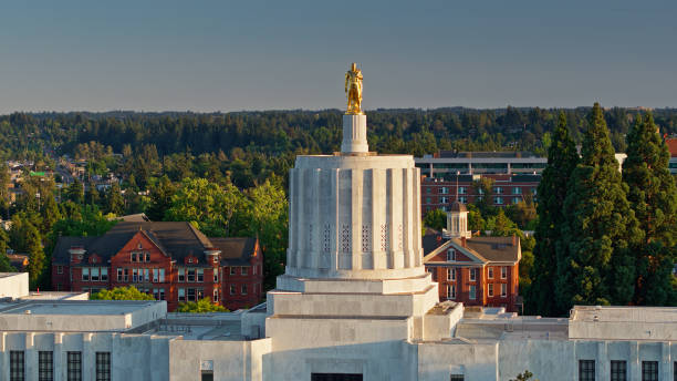 Gold Pioneer Staring Out on Salem, Oregon Aerial shot of the state capitol building in Salem, Oregon on a summer evening. 

Airspace authorization was obtained from the FAA for this operation. oregon us state photos stock pictures, royalty-free photos & images