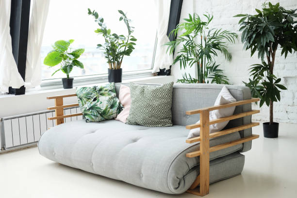 istock grey sofa in the room next to the flowers 1340607641