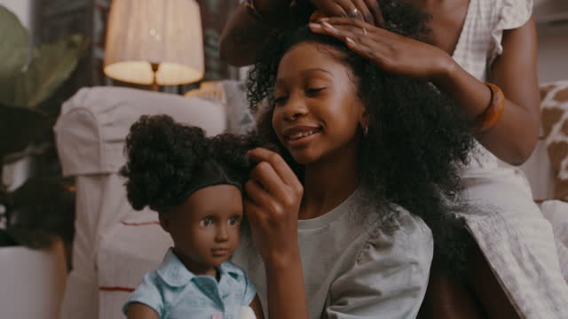4k video footage of a mother brushing her daughters hair at home