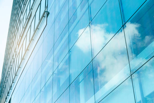 istock Sky and clouds reflected in a modern building glass facade 1340613328