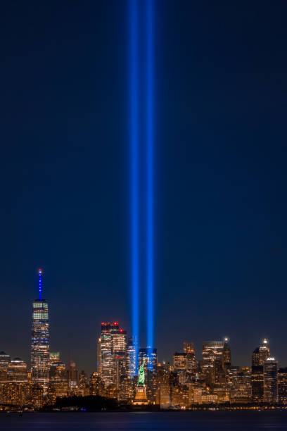 Statue of Liberty Salutes 9/11 Memorial The Statue of Liberty lined up with the Tribute in Light to the struggle against world terrorism statue photos stock pictures, royalty-free photos & images