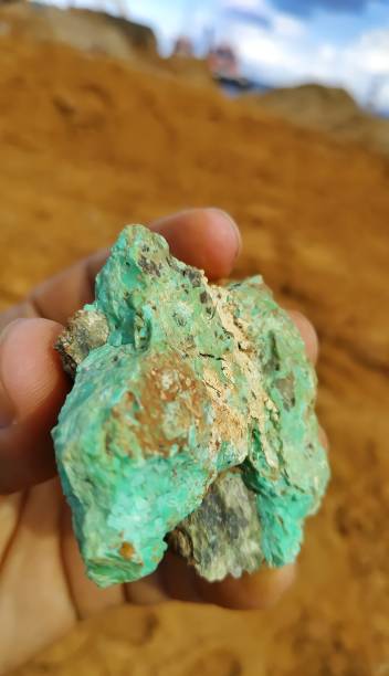 istock A man's hand is holding a green nickel rock 1340617739