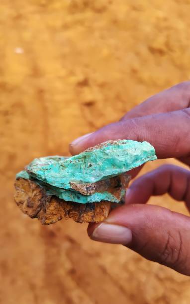 istock A man's hand is holding a green nickel rock 1340617752