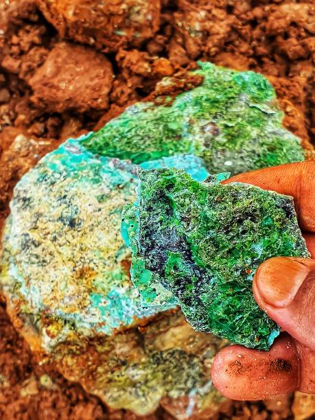 istock A man's hand is holding a green nickel rock 1340617784