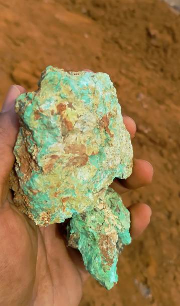 istock A man's hand is holding a green nickel rock 1340617925