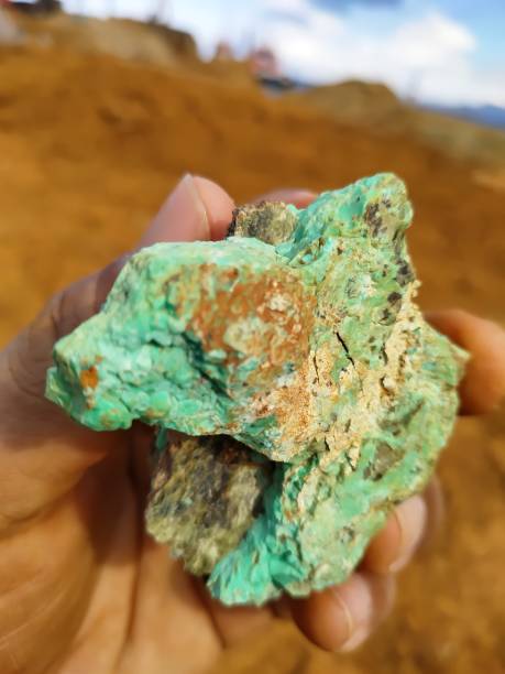 istock A man's hand is holding a green nickel rock 1340617926