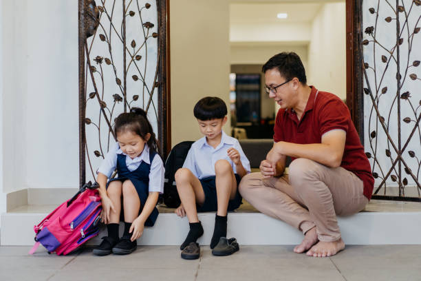 istock Young siblings in school uniform getting ready to go to school 1340627306