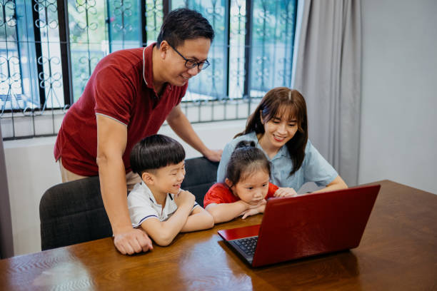 istock Asian Chinese family using laptop at home 1340630357