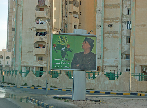 Tripoli, Libya - April 4, 2006: Billboard showing a picture of President Gaddafi positioned outside some run down apartments in downtown Tripoli, Libya.