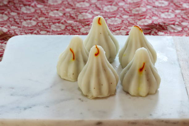 istock Indian sweet momos - Ukadiche Modak on a board with copy space 1340634739