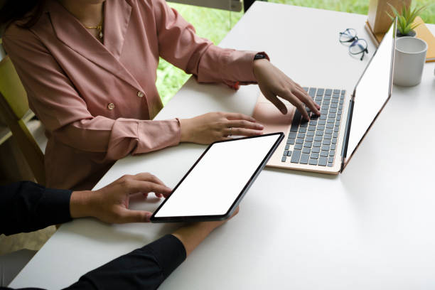 istock Two business colleagues working with modern devices in office. 1340636102