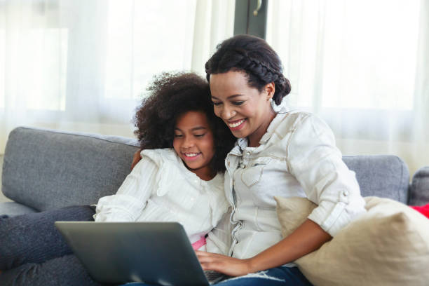 istock Mother And Daughter spending time together on sofa and using Digital Tablet at home 1340639354