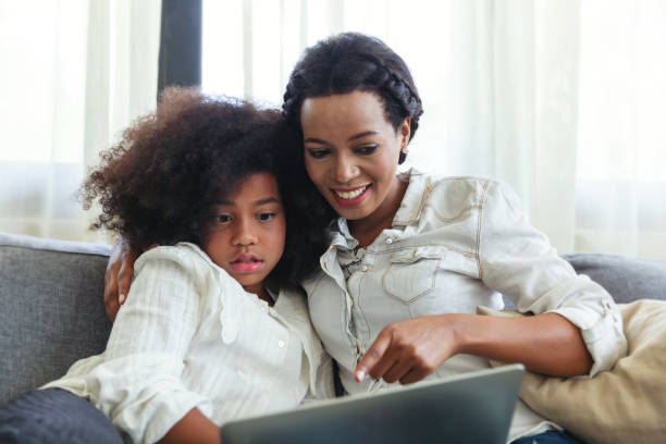 istock Mother And Daughter spending time together on sofa and using Digital Tablet at home 1340639357