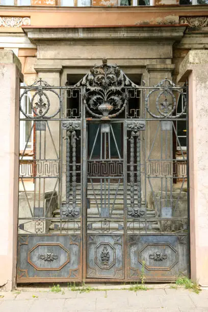 rich decoration with detailed elements forged from metal and used as a three-wing entrance
