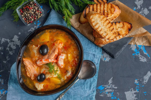 istock Seafood, salmon and cod soup with potatoes. Served with lemon, olives and delicious white bread croutons 1340640373