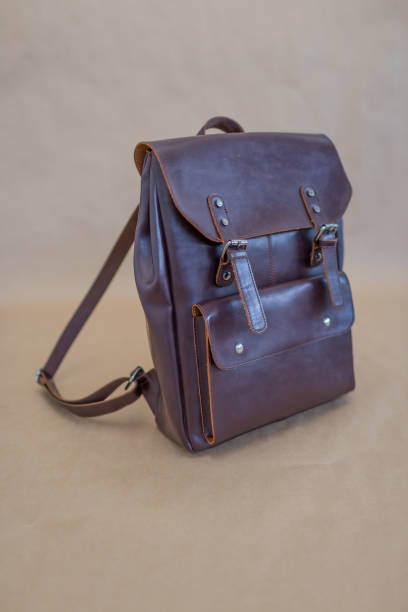 istock Brown leather backpacks isolated on beige background 1340641829