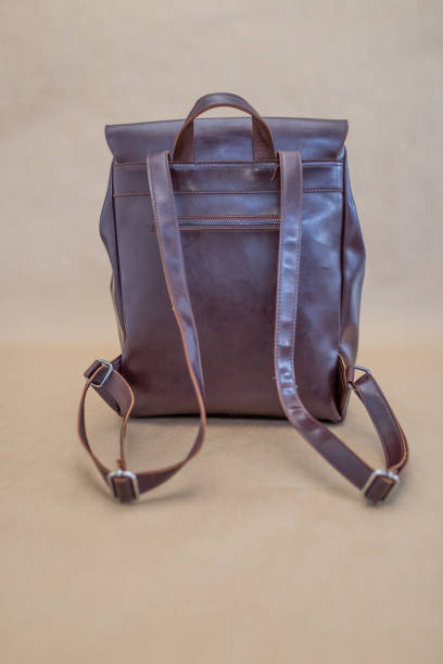 istock Brown leather backpacks isolated on beige background 1340641830