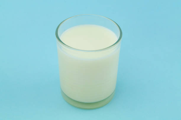 istock Milk in glass on blue background 1340642037