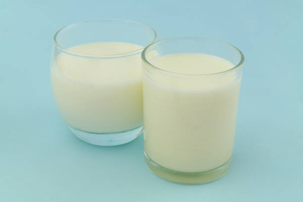 istock Milk in two glasses on blue background 1340642042