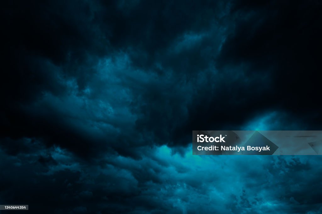 Dramatic blue green sky. Gloomy heavy thunderclouds. Dark teal sky background Dramatic blue green sky. Gloomy heavy thunderclouds. Dark teal sky background with copy space for design. Sky Stock Photo