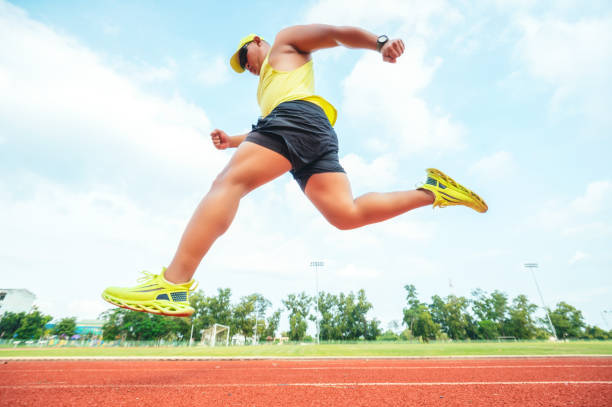 istock Runner using starting block to start his run on race track. Athlete runner feet running on the racetrack.  Young man jogging in track stadium. 1340645134