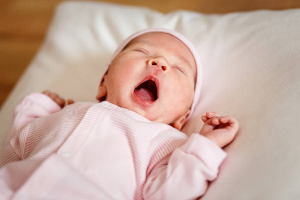 istock Cute newborn baby five-day-old yawns 1340646601