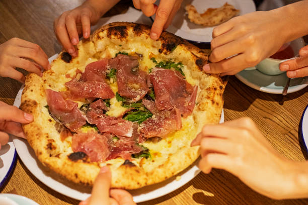 istock grabbing a hot pizza with prosciutto spinach and parmesan close-up, horizontal 1340648211