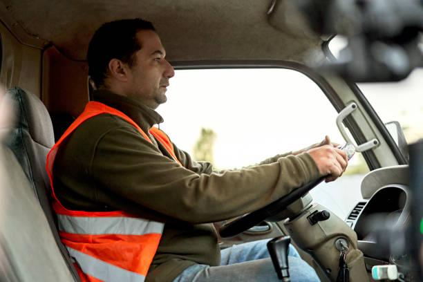 istock Hispanic Truck Driver Sitting in Cab 1340649459