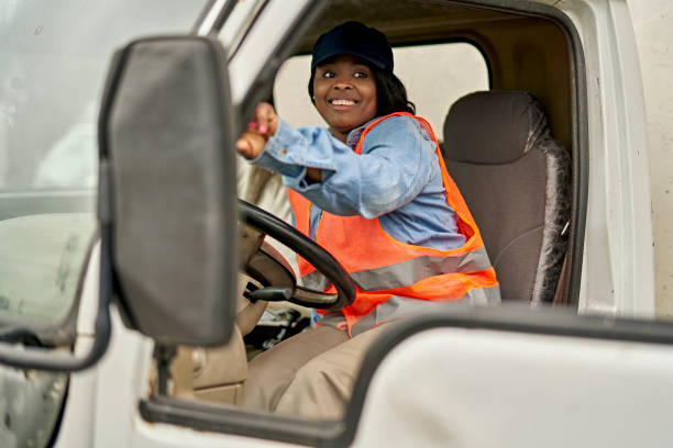istock Female Trucker in Mid 20s Getting into Driver’s Seat 1340649475