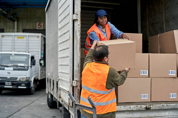 istock Loading Dock Worker Handing Box to Truck Driver 1340649479