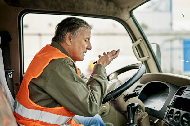 istock Senior Male Trucker Communicating with Smart Phone 1340649713