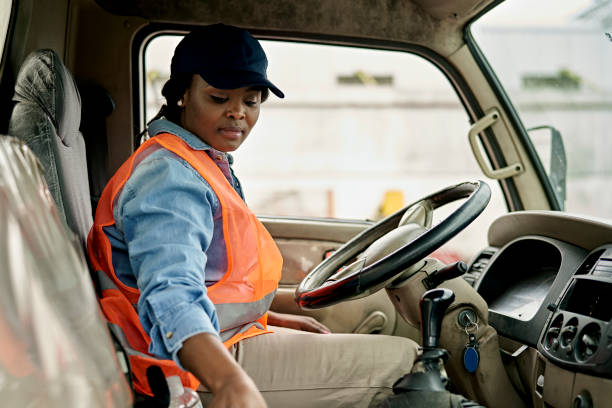 istock Black Female Truck Driver Sitting in Cab 1340649864