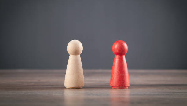 istock Red and brown wooden human figures. 1340650051