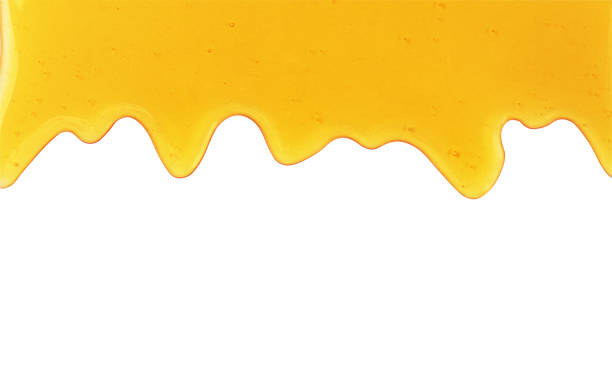 istock Flowing honey closeup isolated on white background. 1340652027