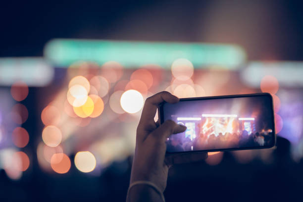 istock Person holding modern smartphone on a concert. 1340654022