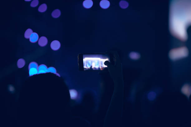 istock Person holding modern smartphone on a concert. 1340654044