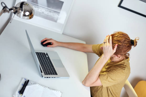 istock Woman working from home on a laptop and having headache. 1340654360